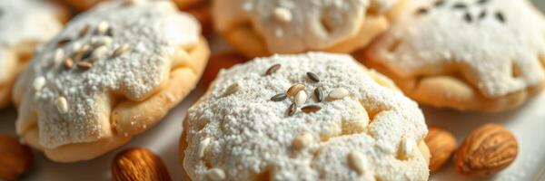 Delicate cookies topped with powdered sugar and seeds served on a white plate photo