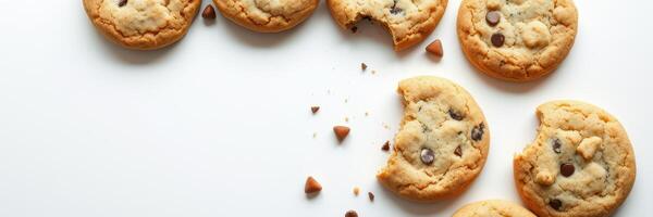 Warm chocolate chip cookies arranged on a clean surface with a few bites taken out photo