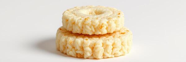 Delicious rice snacks stacked on a white surface, perfect for a light treat or healthy snack option at any time photo