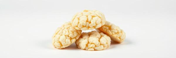 Popcorn-based snacks arranged in a pyramid shape on a plain background photo