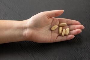 Tablets in a woman hand isolated on white background photo