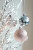 Christmas tree ornaments with glitter on the snow covered decorative branches photo