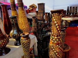 Metallic vases and decor items with intricate embossing and designs made using traditional methods such as hand-engraving or embossing, giving them a vintage and regal aesthetic. photo