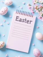 Easter themed flat lay with empty shopping list notepad and decorated eggs for holiday planning photo