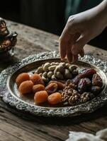 Assortment of mixed nuts, fresh dates, and dried apricots on a decorative plate for festive gatherings photo