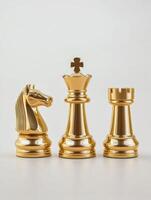 Elegant golden chess pieces set featuring king, queen, and knight for strategic game enthusiasts photo