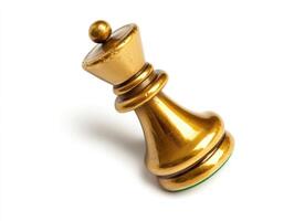 Golden queen chess piece floating in mid air with artistic tilt photo