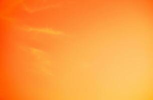 Vibrant orange sunset sky creating a serene and tranquil atmosphere, ideal for climate and environmental concepts or as an emotional and psychological design background, evoking warmth and creativity. photo