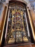 Padua, Italy - July 04, 2022 Ornate and intricate religious altar with golden decorations inside a church. photo