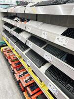 Kyiv, Ukraine - December 15, 2024 Display of computer keyboards with pricing in a retail electronics store photo
