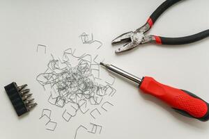 Tools and Staples on White Surface in Minimalist Composition with Copy Space photo