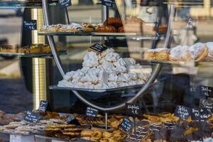 Bakery Window Display of Pastries and Meringues with Price Tags photo