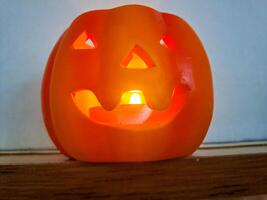 Pumpkin with lighted candles and lanterns for a Haloween holiday photo