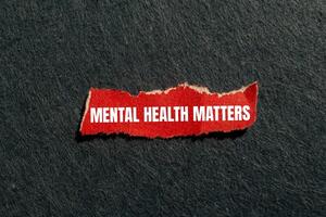 Mental health matters message written on ripped torn red paper piece with gray background. Conceptual mental health matters symbol. Copy space. photo