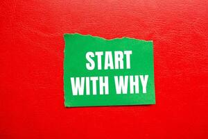 Start with why message written on ripped torn green paper piece with red background. Conceptual start with why symbol. Copy space. photo