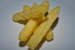a white plate with some fried potato sticks photo