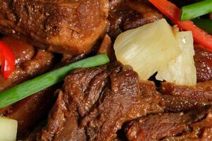 a plate of meat and vegetables with pineapple photo