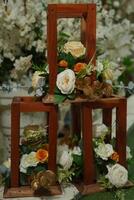 a table with three wooden frames filled with flowers photo
