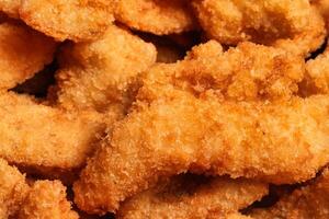 a close up of fried fish fillet photo