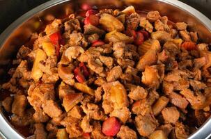 a bowl of meat and vegetables in a pan photo