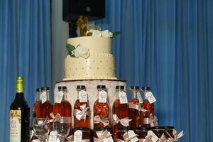 a wedding cake with a bottle of wine on top photo