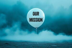 Our mission message written on white balloon on blue background. Conceptual our mission symbol. photo