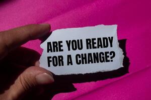 Are you ready for a change message written on ripped torn paper piece with a pink background. Conceptual are you ready for a change symbol. Copy space. photo