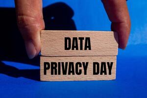 Data privacy day message written on wooden blocks with blue background. Conceptual data privacy day symbol. Copy space. photo