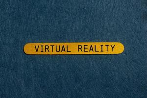 Virtual reality message written on yellow wooden stick with gray background. Conceptual virtual reality symbol. Copy space. photo