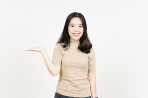 Showing and Presenting Product on Open Palm Of Beautiful Asian Woman Isolated On White Background photo