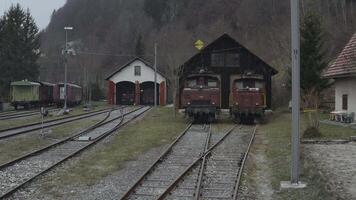 Aerial view of Retro trains at a train depot in the Alps, Switzerland. 4K video