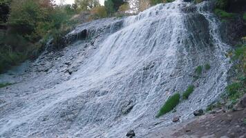 waterfall in mountains, tourists travel through the mountains, stand at the cliff video
