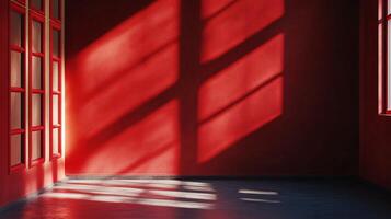 Red room with a window and a wall. The room is empty and the sun is shining through the window, casting shadows on the wall photo