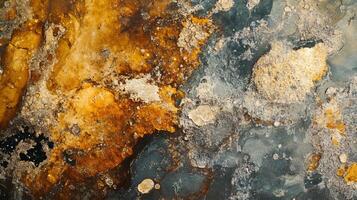 Piece of artwork with a lot of texture and a mix of colors. The colors are mostly brown and blue, with some white spots. The texture of the artwork is rough and uneven, giving it a sense of depth photo