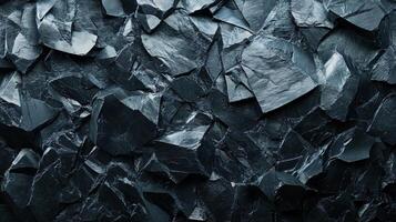 Close up of a black rock with many pieces. The rock is rough and jagged, with a dark color. Concept of ruggedness and strength, as well as a feeling of being in the wilderness or outdoors photo