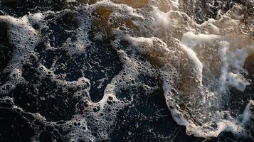 Body of water with a lot of white foam and bubbles. The water appears to be rough and choppy, with waves crashing against the shore. Concept of movement and energy photo