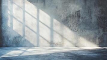Large, empty room with a window that casts a shadow on the wall. The room is bare and unadorned, with no furniture or decorations photo