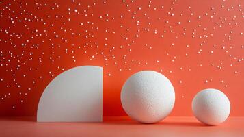 Three white spheres are placed on a red background. The spheres are arranged in a way that they appear to be floating in space. The red background adds a sense of warmth and energy to the scene photo