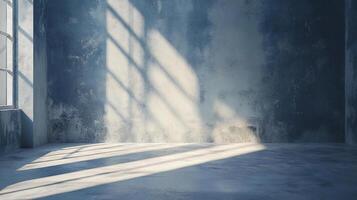 Room with a window and a wall with a shadow on it. The room is empty and has a cold, industrial feel photo