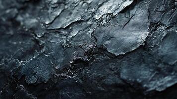 Close up of a rock with a dark blue color. The rock has a rough texture and he is weathered photo