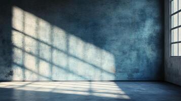 Large, empty room with a blue wall and a window. The window is letting in sunlight, creating a warm and inviting atmosphere photo