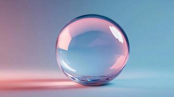 Clear glass sphere with a pinkish hue. The sphere is sitting on a white surface. The sphere is reflective and has a shiny surface photo