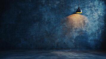 Light shining on a wall with a blue background. The light is on a lamp that is hanging from the ceiling. The room is empty and the light is the only thing that is visible photo