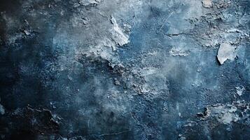 Blue and gray wall with a lot of texture. The wall is covered in paint and has a lot of cracks and holes. Scene is somewhat bleak and desolate photo