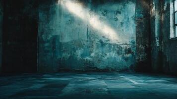 Dark room with a blue wall and a window. The room is empty and has a moody atmosphere photo