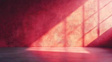 Room with a red wall and a window that is letting in sunlight. The room is empty and has a very bright and warm atmosphere photo