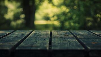 Wooden table with a view of trees in the background. The table is empty and the view is blurry photo