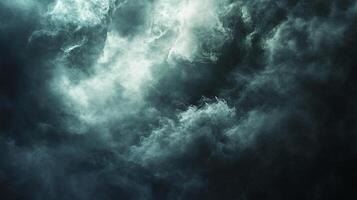 Dark sky with clouds and a sense of foreboding. The clouds are thick and heavy, and the sky is almost black. Scene is ominous and foreboding, as if something bad is about to happen photo
