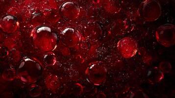 Close up of red bubbles with a dark background. The bubbles are all different sizes and are scattered throughout the image. Scene is playful and whimsical photo