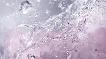 Splash of water with a few drops of pink. The water is in motion, creating a sense of movement and energy. The pink color adds a touch of vibrancy and playfulness to the scene photo